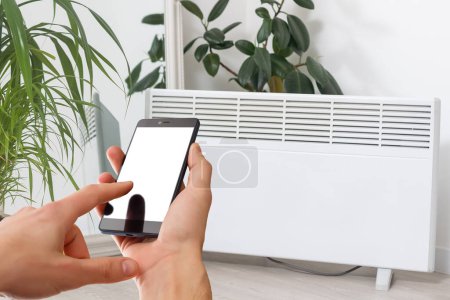 Intelligente Heizungskonvektorsteuerung per Telefon-App. Smart Home mit dem intelligenten Heizsystem. Elektrische Flächenheizung