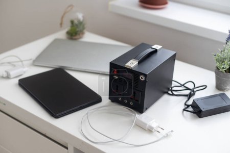 Charging station for phone, tablet, laptop and other gadgets when there is no light during blackout. Generator power bank battery in the absence of electricity. Charge electric rechargeable battery