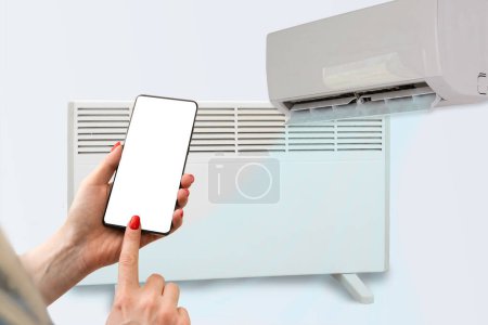 Photo for Electric heater and air conditioner controlled by phone. - Royalty Free Image
