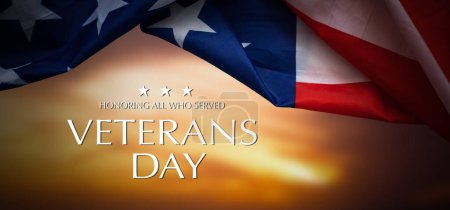 American flags with Text Veterans Day Honoring All Who Served on background. American holiday banner. High quality photo