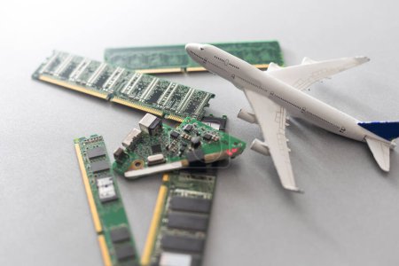 Foto de Electronic circuit board close up with airplan toy. - Imagen libre de derechos