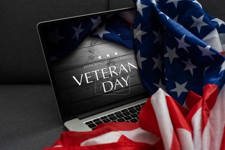 Photo for Veterans day written in laptop with flag of the United States - Royalty Free Image