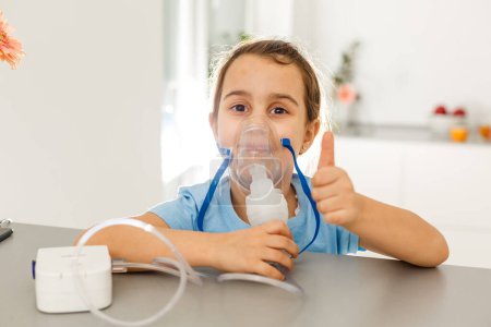 Photo for Cute little girl with nebulizer mask - Royalty Free Image