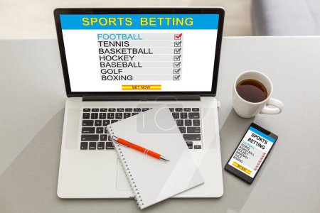 Téléchargez les photos : Sports betting concept on laptop, tablet and smartphone screen over gray table - en image libre de droit