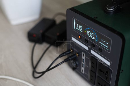 Photo for Portable Power Station is charging gadgets. Modern, information technology. Control panel. close up - Royalty Free Image