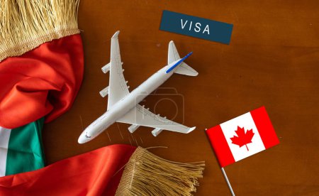 Flag of Canada with passport and toy airplane. Flight travel concep.