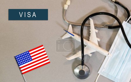 Foto de Flag of United States with passport and toy airplane on wooden background. Flight travel concept. - Imagen libre de derechos