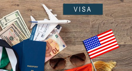 Foto de Flag of United States with passport and toy airplane on wooden background. Flight travel concept. - Imagen libre de derechos