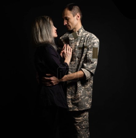 Téléchargez les photos : Military man and his wife on a black background. - en image libre de droit