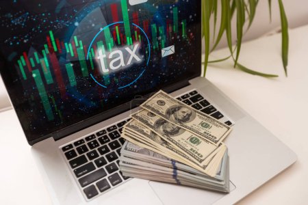 Photo for Laptop and tax money. dollar - Royalty Free Image
