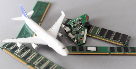 Foto de Electronic circuit board close up with airplan toy. - Imagen libre de derechos