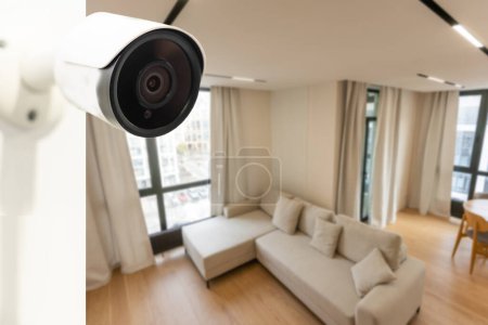 Fermer Vue d'objet d'une caméra de surveillance Wi-Fi moderne avec deux antennes sur un mur blanc dans un appartement confortable a une icône Wi-Fi au-dessus