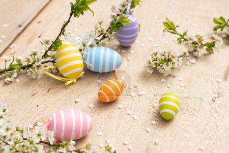 Photo for Happy Easter. Easter eggs on rustic table with cherry blossoms. Natural dyed colorful eggs and spring flowers. Countryside still life. - Royalty Free Image