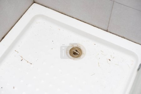 Photo for Removing the old silicone from the shower cabin. - Royalty Free Image