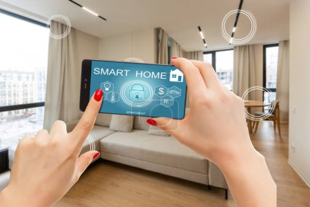 Photo for Internet of things, iot, smart home, kitchen and network connect concept. Human hand holding phone and smart home application to count power usage energy with blur kitchen background. - Royalty Free Image