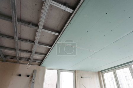 Photo for Ceiling installation with expert technicians In the room that is in the construction process. High quality photo - Royalty Free Image