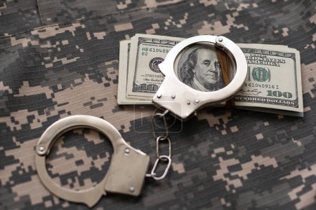 Photo for Military uniform and handcuffs, money. War criminal, criminal liability of military personnel, bribe taker. - Royalty Free Image