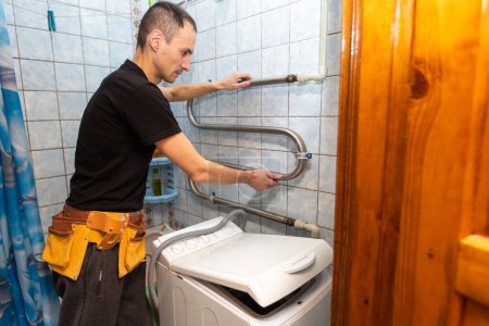 repair of household appliances at home with their own hands. the repairman repairs the washing machine. services for the repair of household appliances at home and in the workshop.