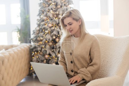 Portrait of attractive cheerful girl watching video resting at christmas.