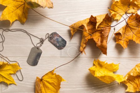 Photo for Dry autumn leaves and old dog tags. - Royalty Free Image