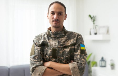 Ein ukrainischer Militärangehöriger hält die Nationalflagge als Symbol der Stärke in den Händen. Krieg in der Ukraine
