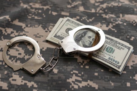 Photo for Military uniform and handcuffs, money. War criminal, criminal liability of military personnel, bribe taker. - Royalty Free Image