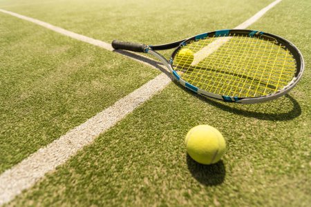 Photo for Tennis racket with a tennis ball on a tennis court. - Royalty Free Image
