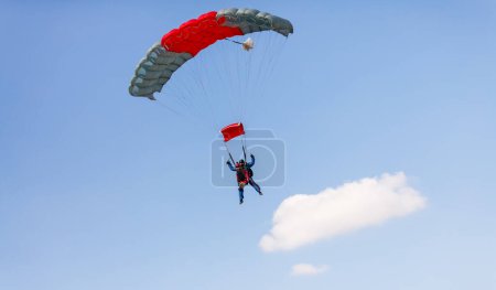 Photo for Skydiver with a little canopy of a parachute on the background a blue sky, close-up. Skydiver under parachute. - Royalty Free Image