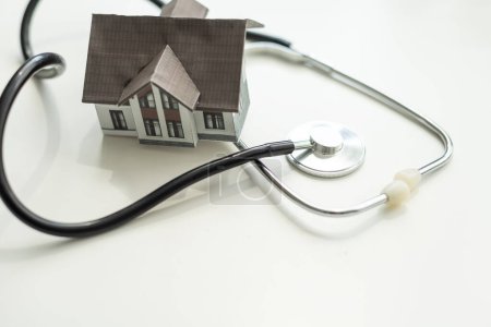 House check. miniature house and stethoscope. High quality photo