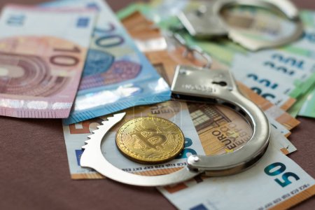 Photo for Handcuffs and a gun lying on the money. High quality photo - Royalty Free Image