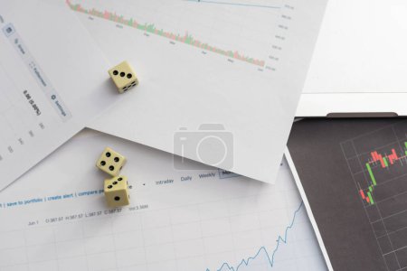 Photo for Dices cubes to trader. Cubes with the words SELL BUY on financial chart and columns of quotations as background. Selective focus. High quality photo - Royalty Free Image