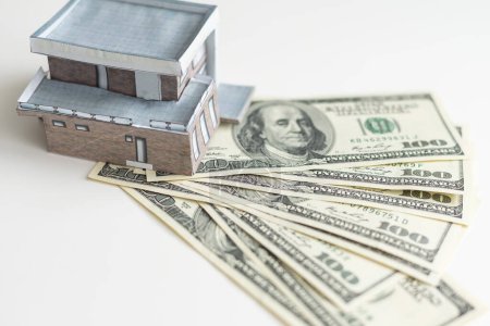 Small Model House on Layer of One Hundred Dollar Bills. High quality photo
