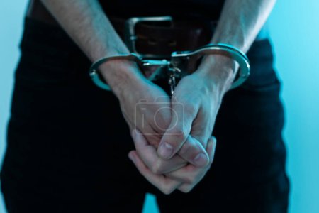 Photo for Prisoner concept, Handcuffed hands of a prisoner in prison, Male prisoners were severely strained in the dark prison, violence. High quality photo - Royalty Free Image