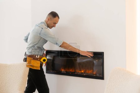 Photo for Fireplace worker, installation and repair. - Royalty Free Image