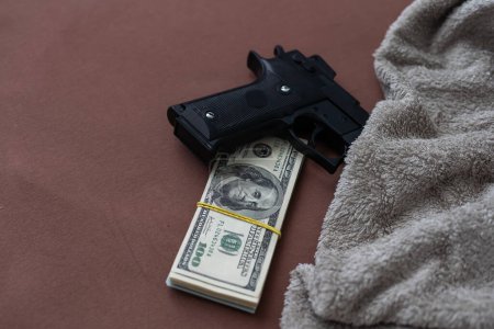 Photo for Black gun on the background of cash dollars. the concept of criminal money or murder for money. bank robbery,. High quality photo - Royalty Free Image
