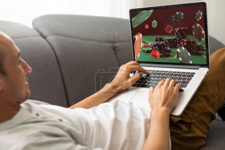 Photo for Man using online sports betting services on phone and laptop. High quality photo - Royalty Free Image
