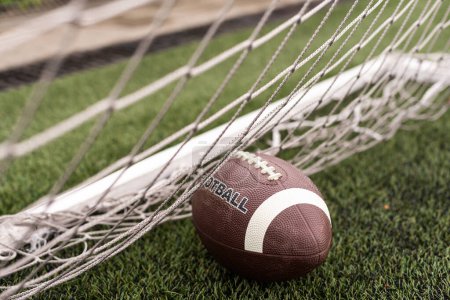 Photo for Photo of an American football on a grass next to the touchline, shot from above. High quality photo - Royalty Free Image