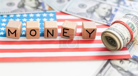 Photo for Word MONEY written by wooden cubes with american flag and american dollar bills. High quality photo - Royalty Free Image