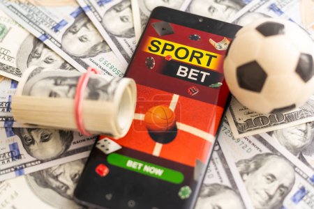 Photo for Smartphone with gambling mobile application and soccer ball with money close-up. Sport and betting concept. High quality photo - Royalty Free Image