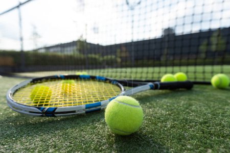 View of empty lawn tennis court with tennis ball. High quality photo