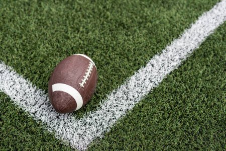 Photo for Photo of an American football on a grass next to the touchline, shot from above. High quality photo - Royalty Free Image