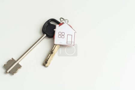 Photo for Key chain with house symbol and keys on white background, Real estate concept. High quality photo - Royalty Free Image