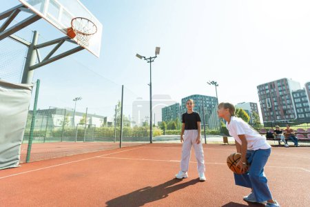 Photo for Children schoolchildren playing a match about basketball against the background. High quality photo - Royalty Free Image