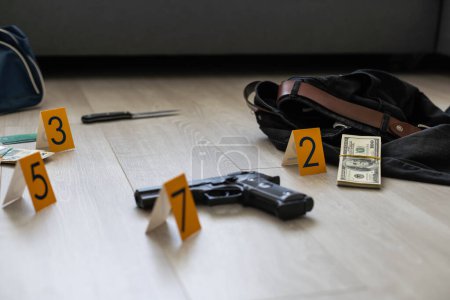 Photo for High contrast image of a crime scene with gun and markers on the floor. High quality photo - Royalty Free Image