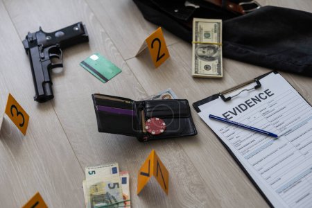 Photo for High contrast image of a crime scene with gun and markers on the floor. High quality photo - Royalty Free Image