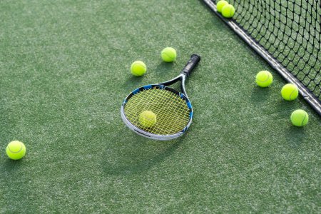 Photo for High angle view of tennis racket and ball by marking on grassy land at tennis court. Copy space, unaltered, sport, competition, green, nature and summer concept. High quality photo - Royalty Free Image