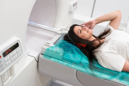 Photo for Female patient undergoing MRI - Magnetic resonance imaging in Hospital. Medical Equipment and Health Care. - Royalty Free Image