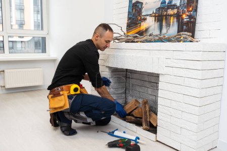 Photo for Service technician repairing a fireplace in a home. High quality photo - Royalty Free Image