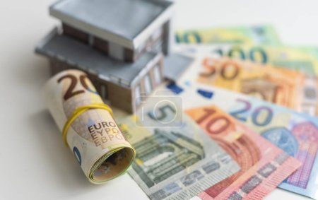 Photo for Model of cardboard house with key and dollar bills. Building, loan, real estate, cost of housing or buying a home concept. High quality photo - Royalty Free Image