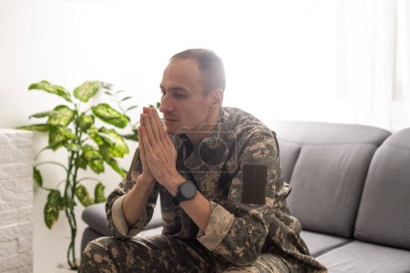 Photo for Young caucasian man wearing camouflage army uniform begging and praying with hands together with hope expression on face very emotional and worried. begging. . High quality photo - Royalty Free Image